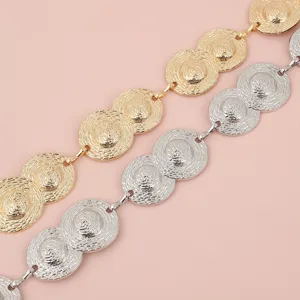 Gold and silver metal chain belt detailed view, textured round disc link design for women.
