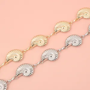 Detailed view of the stylish ocean-style conch shell metal waist chain in gold and silver.