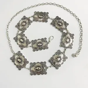 Vintage silver-tone metal waist chain with ornate rectangular plaque links and lobster clasp.