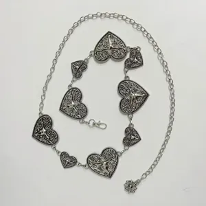 Boho silver heart metal chain belt for women, vintage engraved concho adjustable waist accessory.