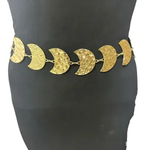 Gold crescent moon metal waist chain detail, stylish body jewelry for women, fashion accessory.