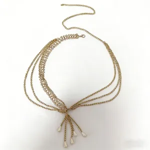 Close-up detail of the multi-layer gold alloy waist chain with elegant pearl pendants for dresses.