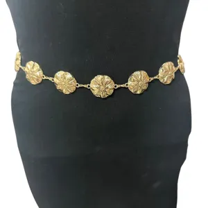 Close-up detail of a vintage gold metallic disc waist chain, perfect for dresses and boho style.