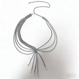 Close-up detail of the metallic multi-layer body chain, featuring delicate dangling drop pendants.