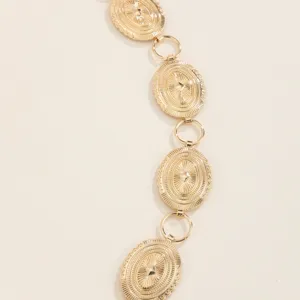 Close-up detail of the vintage gold metal waist chain, featuring ornate disc links and fine texture.