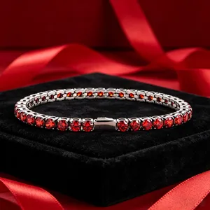 Stunning silver-tone tennis bracelet featuring sparkling red cubic zirconia stones.