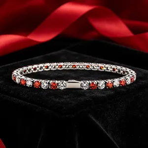Detailed close-up view of the stainless steel tennis bracelet with red and white cubic zirconia.