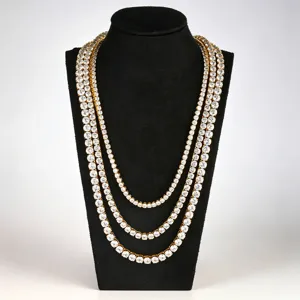 Detailed view of multi-layer gold tennis chain necklace sparkling with cubic zirconia stones.
