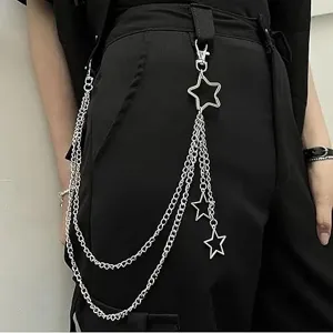 Close-up detail of hip hop punk multi-layer metal pants chain with hollow star pendants.
