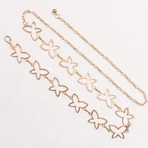 Detail view of gold metal hollow butterfly waist chain, elegant fashion dress accessory.