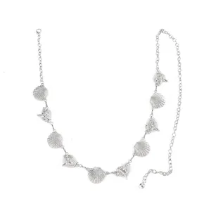Silver tone metal waist chain featuring seashell and conch charms, bohemian body jewelry detail.