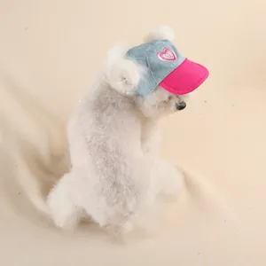 Cute denim pet hat for small dogs with pink brim and heart embroidery, stylish and adorable pet accessory.