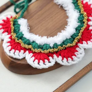 Detailed shot of Christmas crochet pet collar in red white green with gold trim for dogs.