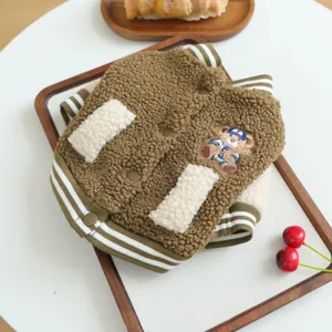 Pet fleece baseball jacket detail shot, warm brown lamb wool fabric, cute bear embroidery.