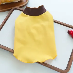 Pet clothing detail view showing yellow fabric and brown collar on a white tray background.