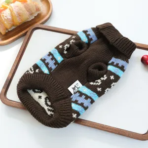 Detailed close-up of a cozy brown knit pet sweater with blue white geometric patterns.