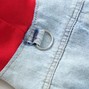 Detail view of pet denim jacket featuring red hood lining, blue fabric, and metal D-ring.