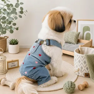 Detailed view of cute small dog denim overalls jumpsuit featuring sweet pink and red heart embroidery.
