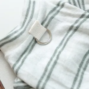 Pet clothes detail shot showing soft striped fabric and a metal D-ring for leash attachment.