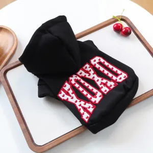 Detail view of black pet hoodie with YUKO embroidery for small dogs and puppies.