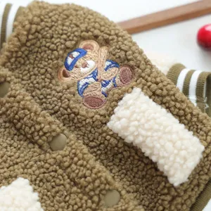 Brown fleece pet baseball jacket close-up view with cute bear embroidery and metal snap buttons.
