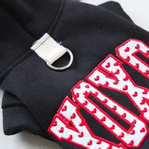 Pet hoodie detail shot showcasing breathable black fabric with cute heart embroidery.