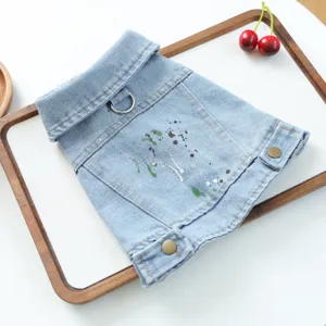 Detail view of denim pet jacket for small dogs with paint splatter, lapel and leash ring.