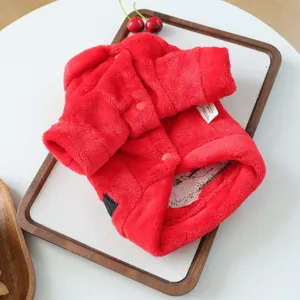 Red fleece pet coat detail shot, soft plush warm puppy winter clothing with cute buttons design.