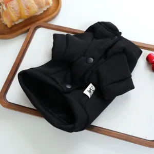 Detailed view of black pet hoodie for small dogs, soft knit fabric with snap buttons.