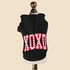 Close-up of black pet dog hoodie with cute heart-patterned XOXO embroidered detail on back.