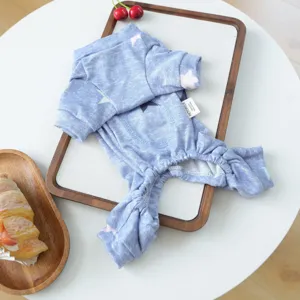 Detailed view of blue star print pet loungewear with cozy fabric flat lay on wooden tray.