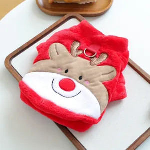 Detailed view of cute plush Christmas pet coat with sweet reindeer face and cozy red fabric.