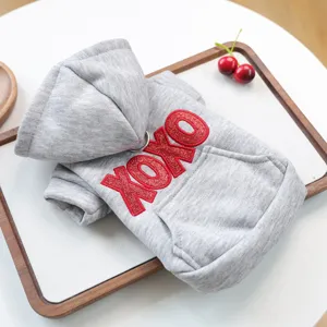 Grey pet hoodie with hood, pocket and red glitter XOXO print, perfect detail view for small dogs.