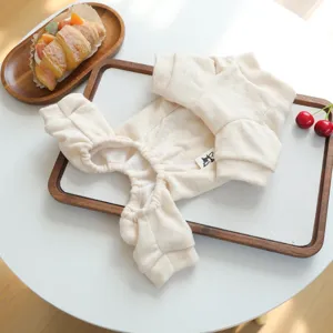 Soft beige pet loungewear detail view, cozy winter dog clothes with cute design elements.