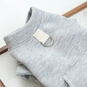 Detailed close-up of grey pet hoodie for small dogs with traction D-ring and pocket design.