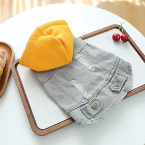 Detailed view of trendy pet denim jacket with attached yellow hood, perfect spring apparel for small dogs.