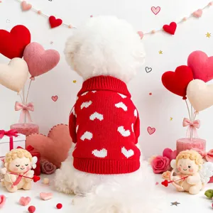 Cute red pet dog sweater with white heart patterns, cozy knitted apparel for small dogs detail view.