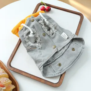 Detailed close-up view of grey pet denim hoodie jacket with yellow lining and frayed design.