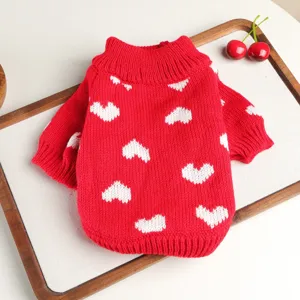 Red knit dog sweater detail showing soft woolen texture and cute white heart patterns design.