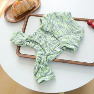Detailed view of green and grey plaid knitted pet jumpsuit, soft fabric and design details.
