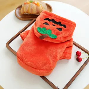 Detail shot of orange pumpkin pet hoodie with cute green leaf hood, soft fleece fabric for small dogs.