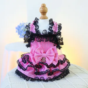 Pink checkered pet dress with black lace and bow, detailed view of cute puppy cat apparel.