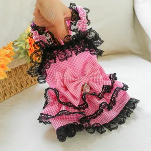 Cute pink checkered pet dress with black lace ruffles and bow for small dogs and cats detail.