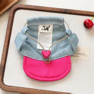 Cute denim and pink pet cap accessory with heart buckle for small dogs and puppies detail view.