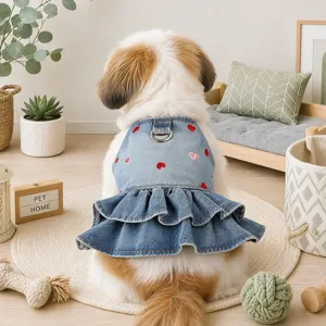 Detail view of cute pet denim dress with red heart embroidery and double ruffled hem.