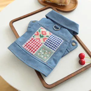 Close-up detail of denim pet dog jacket featuring a classic lapel and cute multi-color patchwork style.