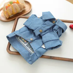 Detailed view of trendy blue denim pet dog jacket with lapel collar and metal snap buttons.