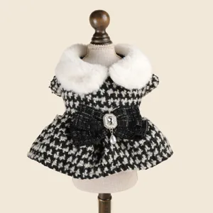 Gros plan sur la robe pour animal avec col en fausse fourrure et pendentif perle.