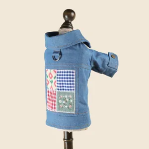 Denim pet jacket detail view featuring chic patchwork, lapel collar, and metal leash ring.
