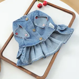 Cute denim pet dress detail shot featuring heart embroidery and stylish ruffle hem.